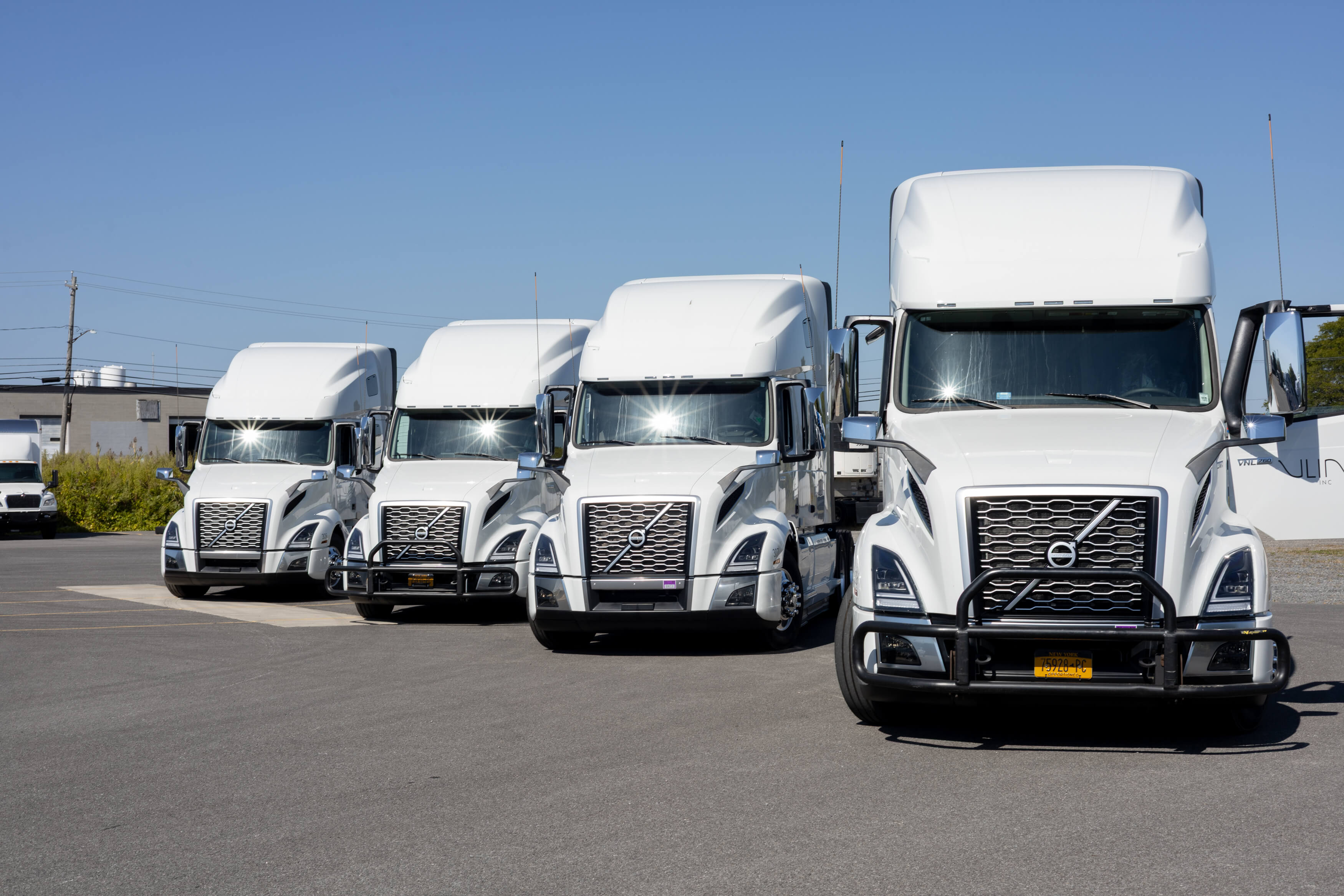 White Volvo trucks in the V-Line yard